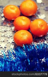 Fresh oranges over Christmas decorations