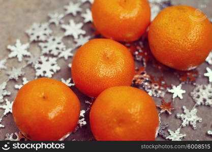 Fresh oranges over Christmas decorations