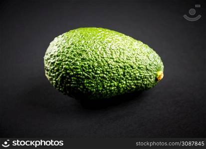 Fresh organic avocado isolated on a black background. Avocado isolated on a black background