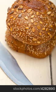 fresh organic bread over rustic table macro closeup