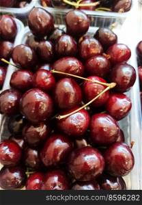 fresh organic cherries in plastic box