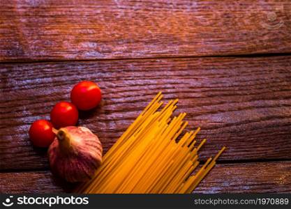 Fresh organic cherry tomatoes with garlic and pasta