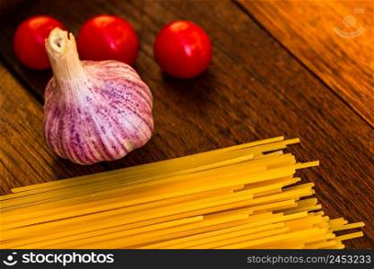 Fresh organic cherry tomatoes with garlic and pasta