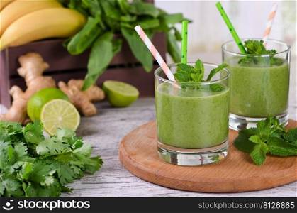 Fresh organic detox green drink smoothie with celery, spinach, banana, cilantro, lime and ginger with refreshing mint. Healthy, dietary, vegetarian food