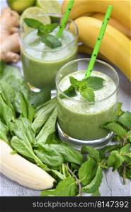 Fresh organic detox green drink smoothie with spinach, banana, lime and ginger with refreshing mint. Healthy, dietary, vegetarian food
