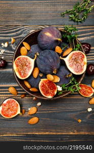 Fresh Organic Figs and nuts on wooden background or table. Figs and nuts on wooden background