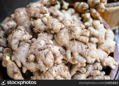 Fresh organic ginger on fresh market in thailand, fresh ginger plant farm harvest ginger root on field agricultural for sold in the market