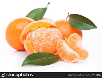 Fresh organic mandarins tangerines fruits with leaves with peeled halves on white background