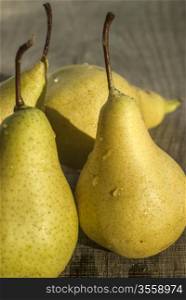 Fresh organic pears closeup on wooden board background