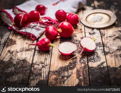 Fresh organic radish with salt on rustic kitchen table. Simple food or vegetarian concept.