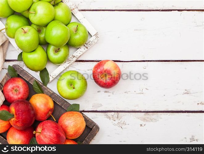Fresh organic red and green apples in vintage box on wooden background. Space for text