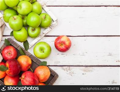 Fresh organic red and green apples in vintage box on wooden background. Space for text