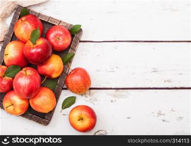 Fresh organic red healthy apples in vintage box on wooden background.