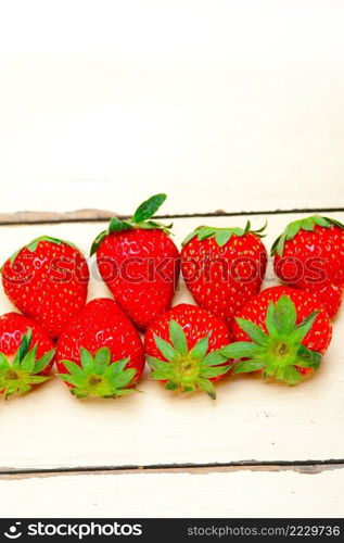 fresh organic strawberry over white rustic wood table