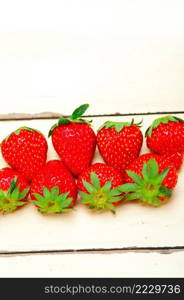 fresh organic strawberry over white rustic wood table