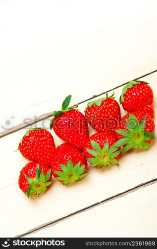 fresh organic strawberry over white rustic wood table