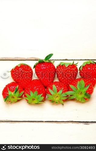 fresh organic strawberry over white rustic wood table