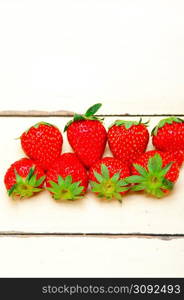 fresh organic strawberry over white rustic wood table