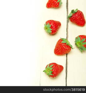 fresh organic strawberry over white rustic wood table