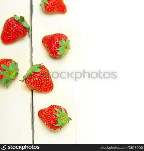 fresh organic strawberry over white rustic wood table