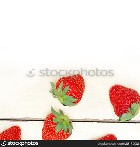 fresh organic strawberry over white rustic wood table