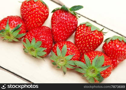 fresh organic strawberry over white rustic wood table