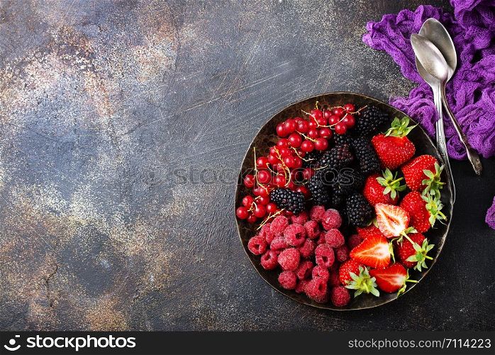 Fresh organic summer berries mix in round plate