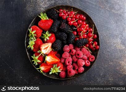 Fresh organic summer berries mix in round plate
