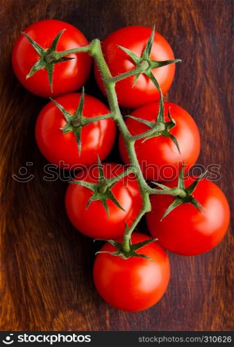 Fresh organic tomatoes on grunge wooden background . For kitchen