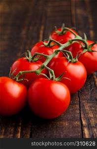 Fresh organic tomatoes on grunge wooden background . For kitchen
