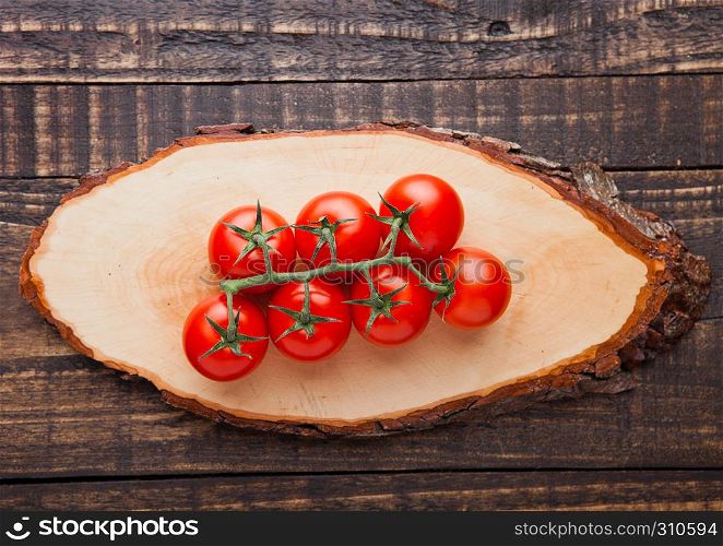 Fresh organic tomatoes on wooden board background. Best for kitchen.