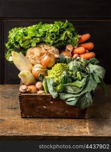 Fresh organic vegetables from garden in old rustic wooden box, healthy food concept