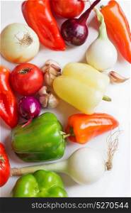 Fresh organic vegetables heap against white background