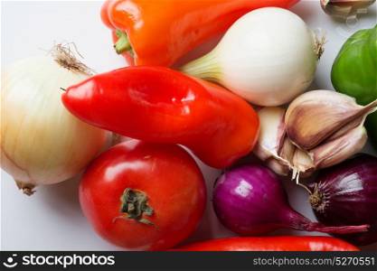 Fresh organic vegetables heap against white background