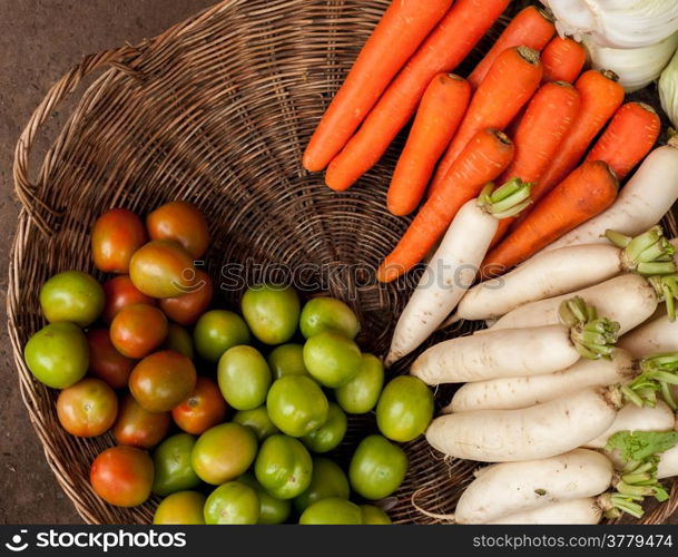 Fresh organic vegetables in wicker baskets at asian market