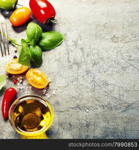 Fresh organic vegetables on rustic background (tomatoes, basil, garlic, olive oil). Healthy food. Vegetarian eating. Fresh harvest from the garden.