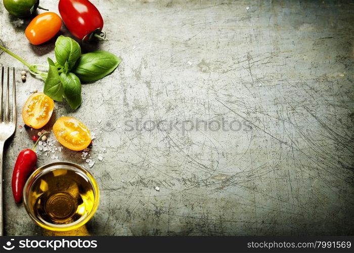 Fresh organic vegetables on rustic background (tomatoes, basil, garlic, olive oil). Healthy food. Vegetarian eating. Fresh harvest from the garden.