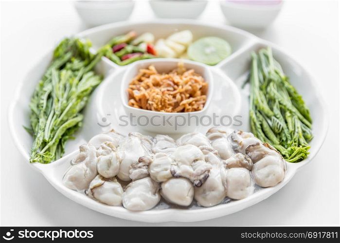 Fresh Oyster serve with assorted vegetable on white background