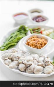 Fresh Oyster serve with assorted vegetable on white background