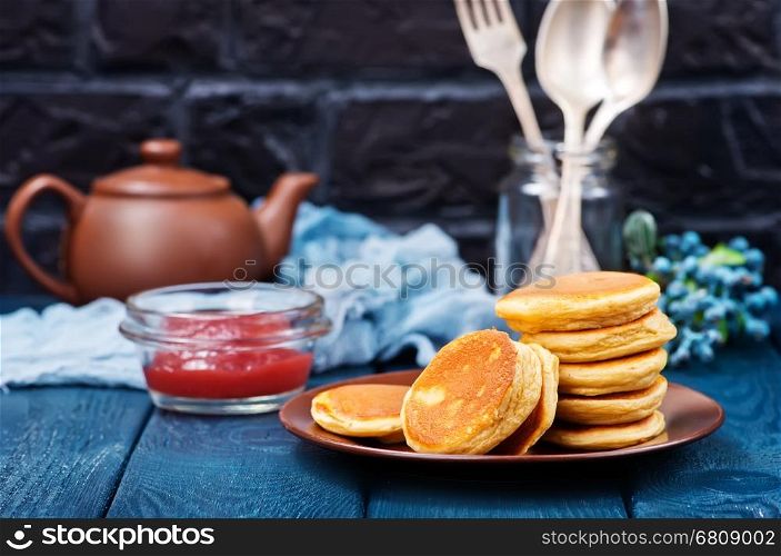 fresh pancakes on plate and on a table