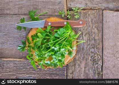 fresh parsley on wooden board and on a table