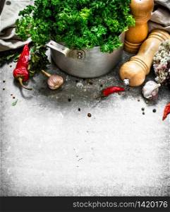 Fresh parsley with spices . On a stone background.. Fresh parsley with spices