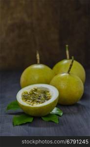 Fresh passion fruit and half over wooden background , still life