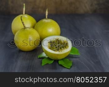 Fresh passion fruit and half over wooden background , still life