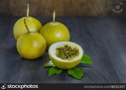 Fresh passion fruit and half over wooden background , still life