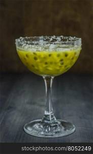 Fresh passion fruit juice in glass over wooden background , still life