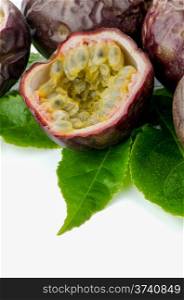 Fresh passion fruit with green leaves isolated on a white background