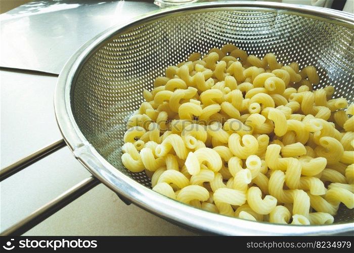Fresh pasta in a stainless steel silver strainer