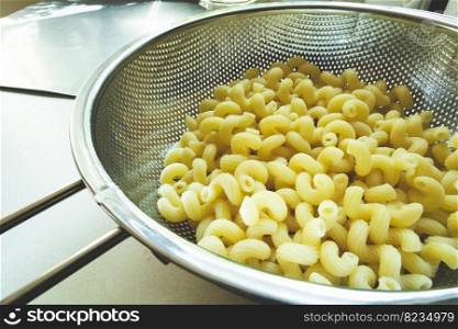 Fresh pasta in a stainless steel silver strainer