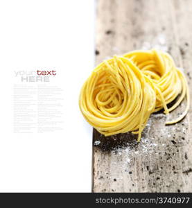 Fresh pasta on wooden table (with easy removable sample text)